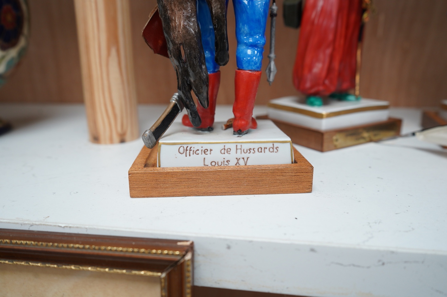 A set of four French porcelain military figures on stands to include ‘Hussards De Bercheny Officer’ and ‘Garde Du Corps’, largest 26cm high. Condition - mostly good condition with some minor losses